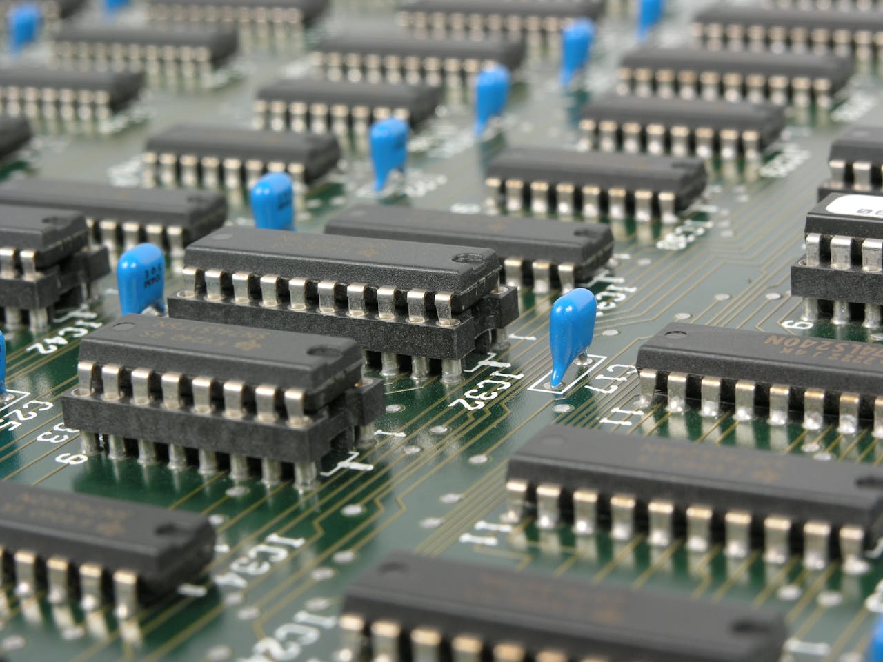 Detailed macro shot showcasing integrated circuits and components on electronic motherboard.